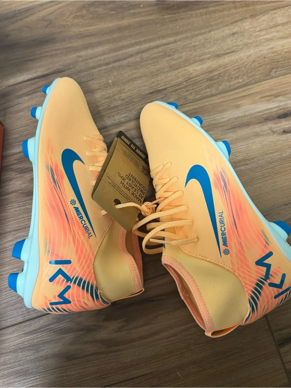 Nike Kids Orange Soccer Cleats with Blue Swoosh